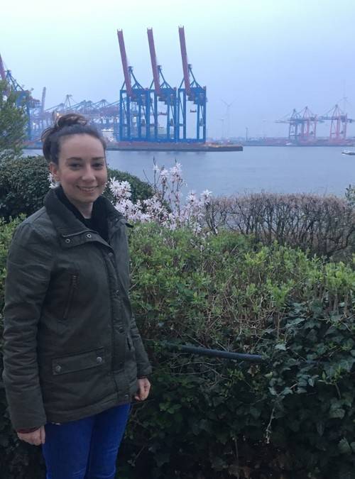 Elly Rosenthal in front of shipping cranes in Germany